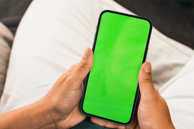 Girl holding a smartphone with green screen Chroma Key