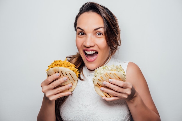 Girl holding Venezuelan arepas