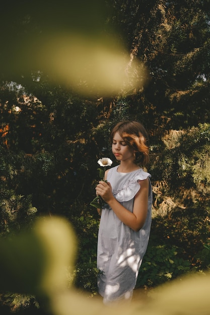 girl holding white daisy