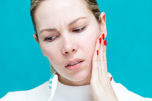 Girl holds on to a bad tooth, toothache, severe sharp pain,\
oral cavity