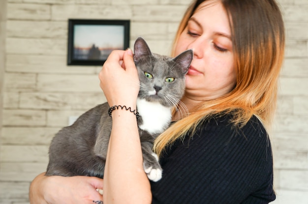 Girl holds beloved cat in her arms