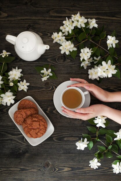 a girl holds a cup of tea