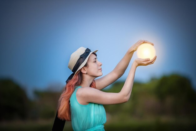 Girl holds in the hands the moon is a fabulous way