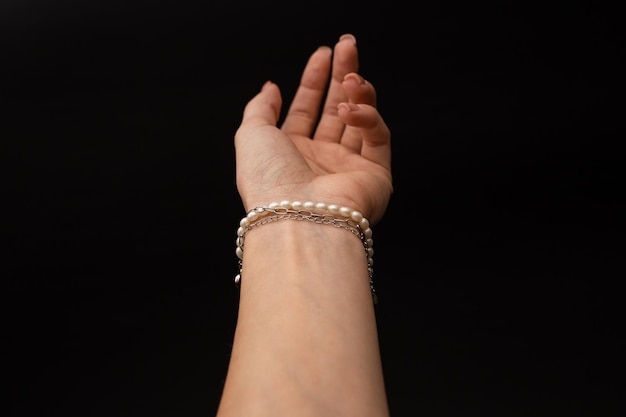 A girl holds in her hand a beautiful product made of silver and gold a decoration accessory