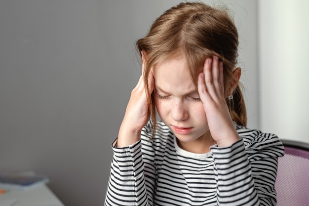 The girl holds her hands on the temples. fatigue, headache. mental health