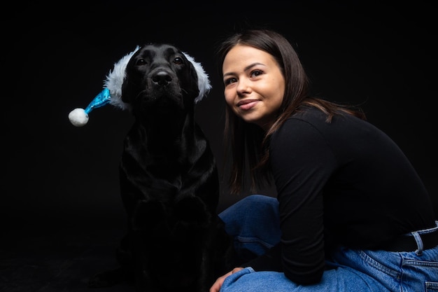 A girl holds a Labrador Retriever dog in her arms