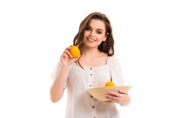 The girl holds a lemon in her hands and promotes a healthy lifestyle