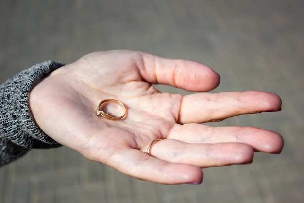 사진 소녀는 그녀의 손바닥에 반지를 보유하고 있습니다. 여자는 그녀의 손에 반지를 보유하고 있습니다 어린 소녀는 그녀의 손바닥에 반지를 보유하고 있습니다