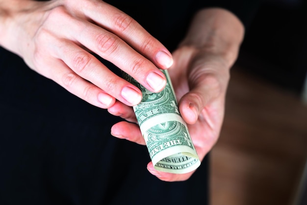 girl holds a wallet in her hands shopping dollars in her purse wallet full of dollars