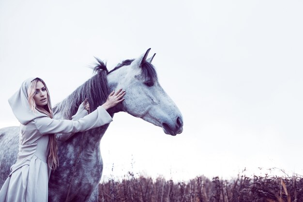  girl in the hooded cloak  with horse,  effect of toning