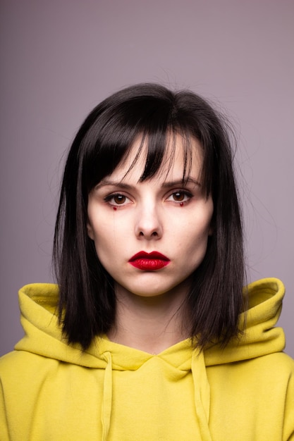 girl in a hoodie with red lipstick on her lips