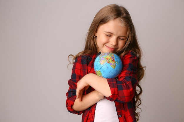 Girl hugging Earth globe