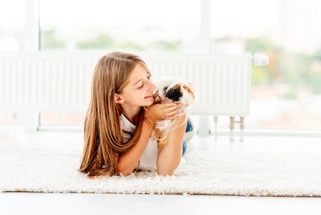 Girl hugging guinea pig