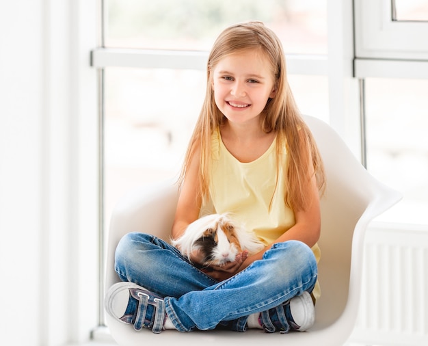 Girl hugging guinea pig