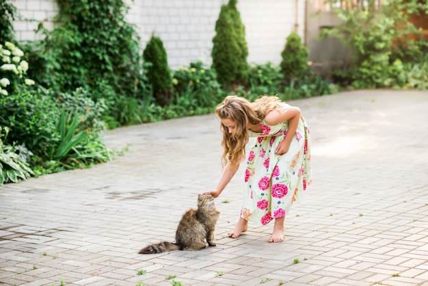 Girl hugging her dog wearing beautiful dress with a dog