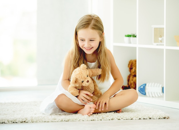 Girl hugging teddy bear