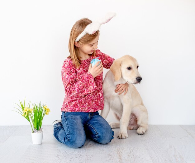 Girl hugging young dog