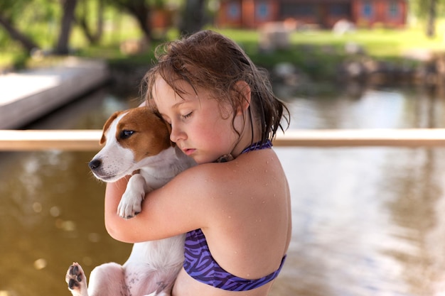 Girl hugs Jack Russell Terrier