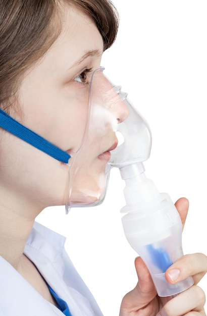 Girl inhales with face mask of modern inhaler