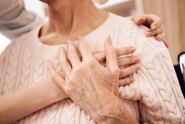 Girl is caring for elderly woman at home.