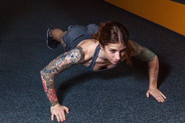 The girl is doing exercises in the gym. Fitness training in the gym.