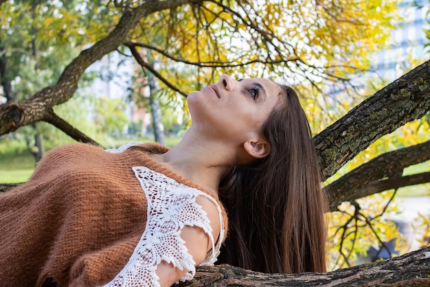 A girl is dotting on a tree branch