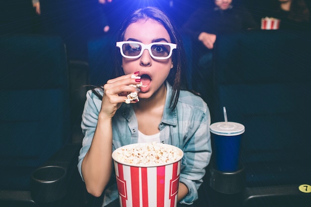 Girl is eating popcorn