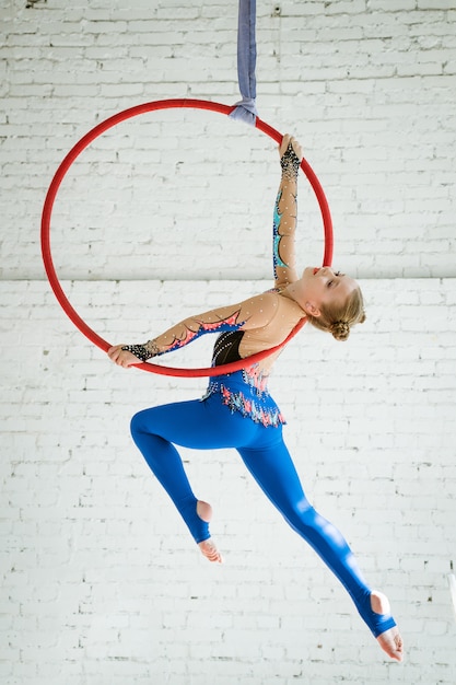 The girl is engaged in air gymnastics in a circle