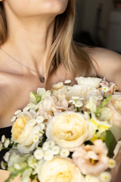 A girl is holding a bouquet of flowers