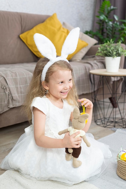 a girl is holding easter eggs and smiling