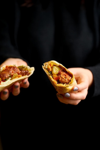 A girl is holding a kebab shawarma Selective focus