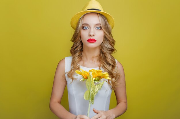 girl is holding a sunflower