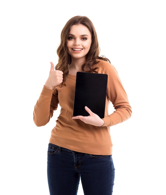 The girl is holding a tablet in her hands Place for text