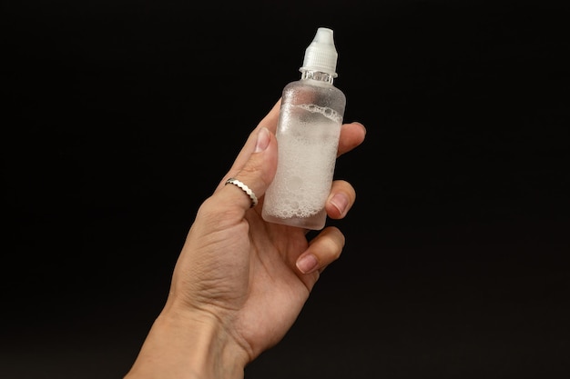 A girl is holding a vial of liquid in an urk