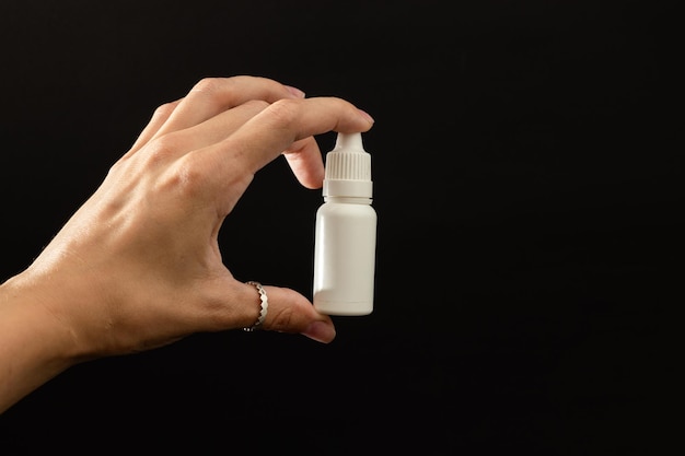 A girl is holding a vial of liquid in an urk