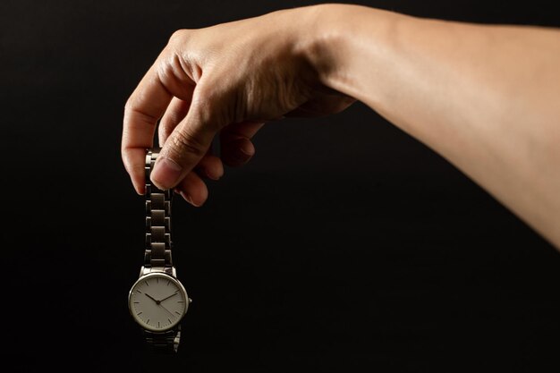 A girl is holding a watch