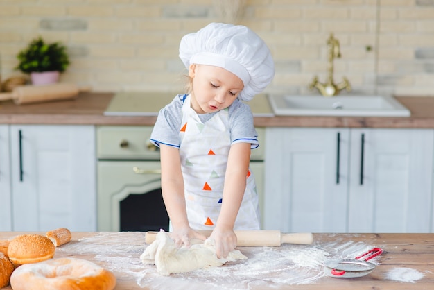 girl is learning how to make a cake