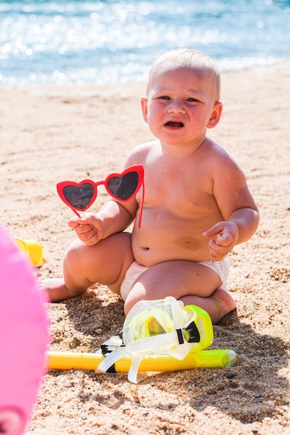 A girl is playing on the beach sand with the sunny day