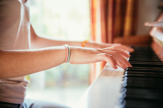 Girl is playing piano at home high angle view blurry background