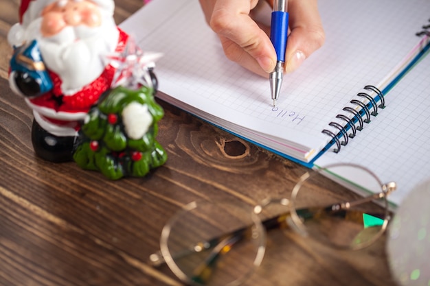 A girl is ready to write a letter to Santa Claus