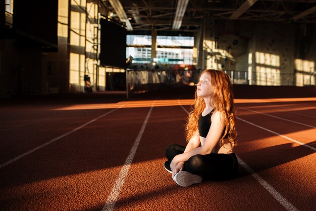 girl is resting after a workout in the gym