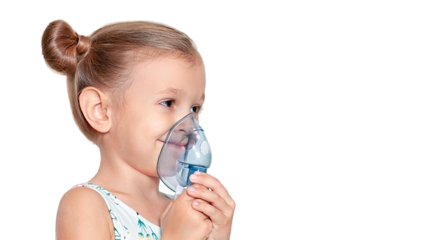 The girl is smilling in the inhalation mask