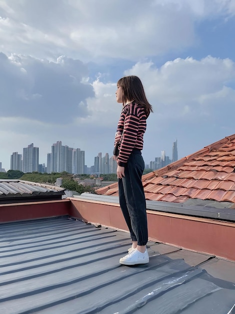 A girl is standing on the roof