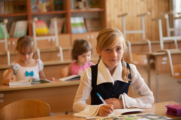 Girl is studying in classrom at the desk