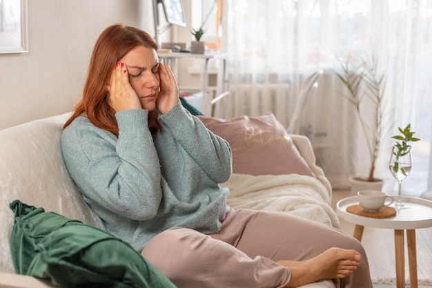 girl is suffering from a headache