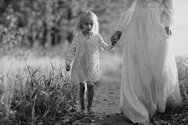 girl is with her mother in the autumn field