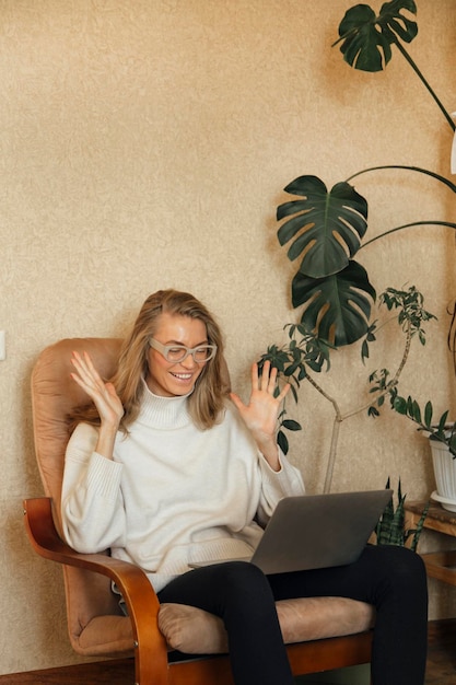 the girl is working on a laptop at home