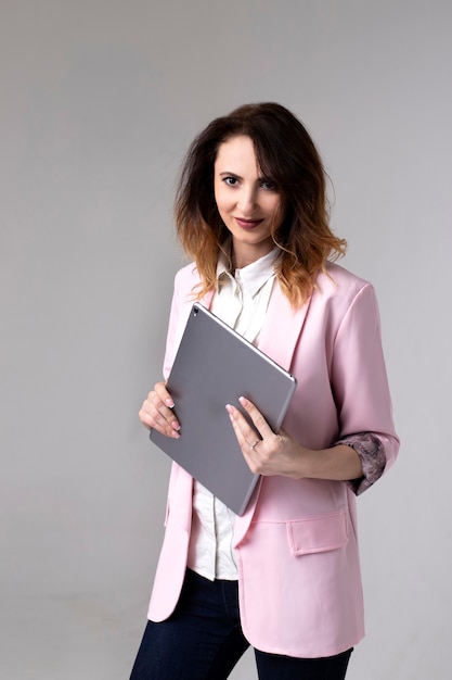 Girl in a jacket with a tablet