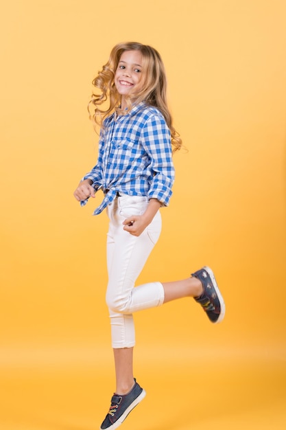 Girl jump on orange background