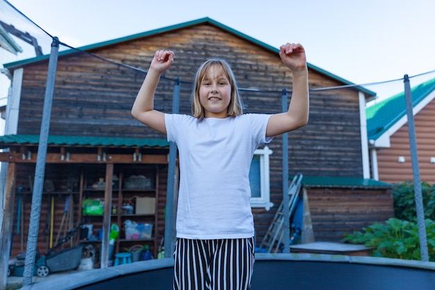 Girl jumps and plays on trampoline